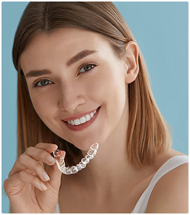 woman smiling with clear aligner