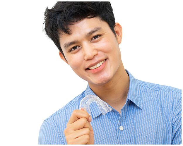 man holding clear aligner