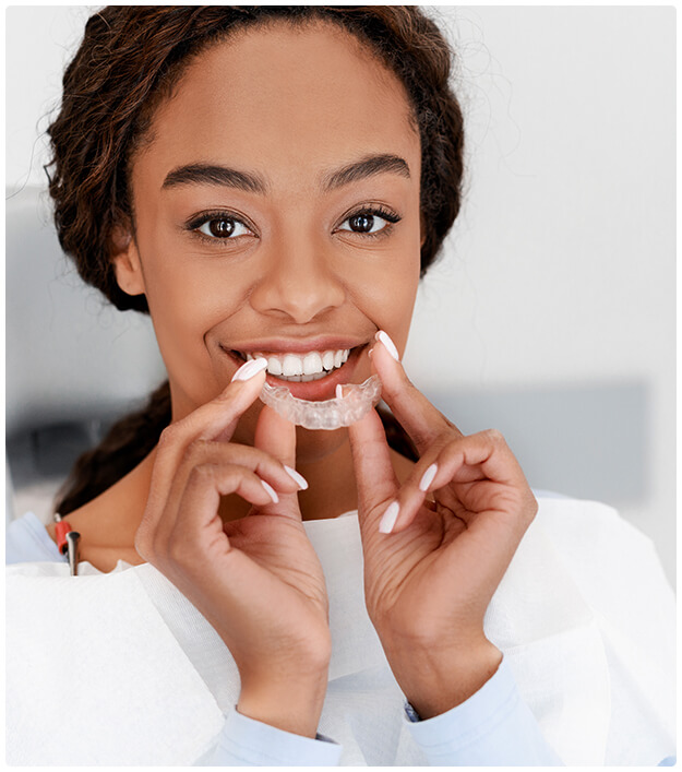 woman putting in clear aligners