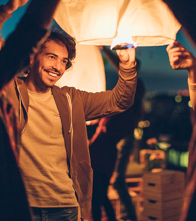 man lighting lantern