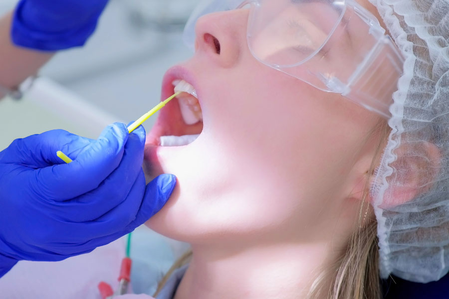 dental patient receiving a fluoride treatment