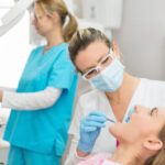 woman gets dental sealants at the dentist office