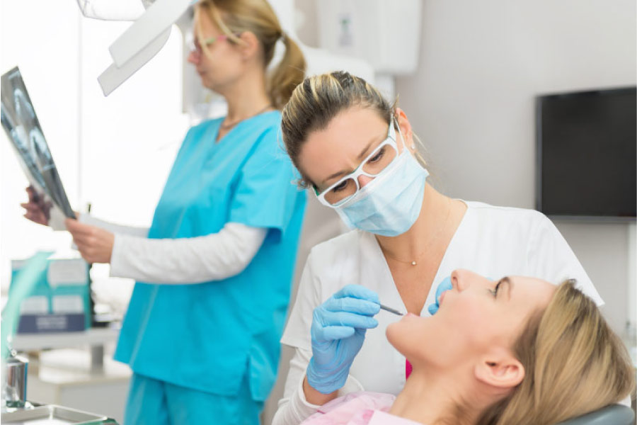 woman gets dental sealants at the dentist office