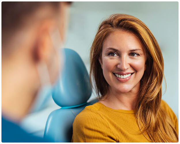 smiling woman sitting in a dental chair