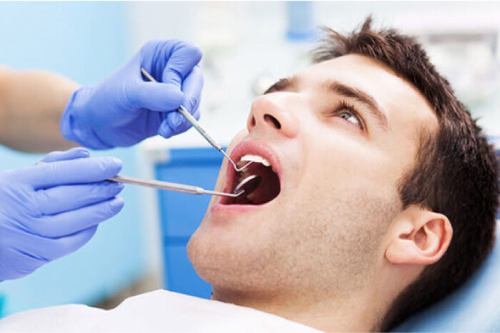 man gets an oral cancer screening at the dentist office